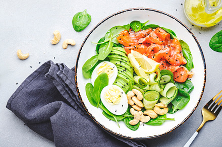 Keto salad bowl with salmon, avocado, spinach, cucumber, eggs, c, a Food & Drink Photo by 5PH