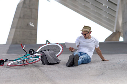 Young man relaxing on the floor and listening music