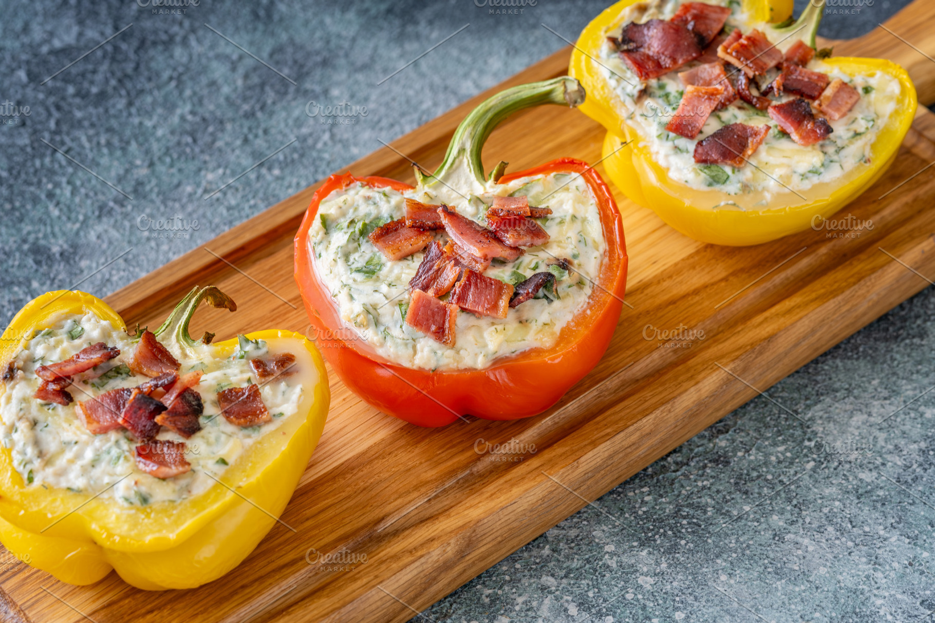 Stuffed Bell Peppers With Bacon Garnish On Rustic Serving Board, a Food & Drink Photo by Alexander Prokopenko