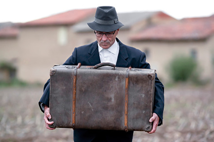 emigrant with suitcase and vintage suit leaving his village to l