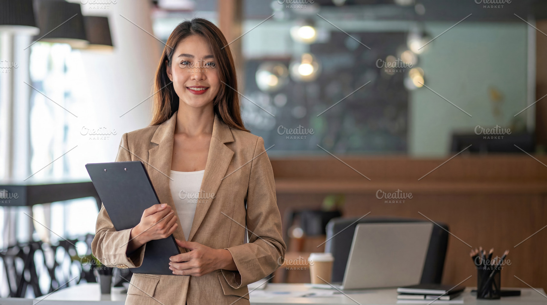 Young Businesswoman Holding Clipboard in Modern Office, a Business Photo by Davizro's Market