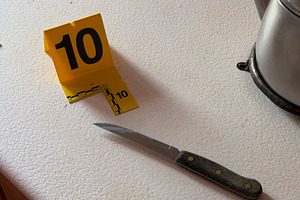 Crime scene evidence marker next to knife at home