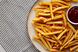 Homemade Golden French Fries with Ketchup, top view. Copy space., a Food & Drink Photo by LiudmylaChuhunova