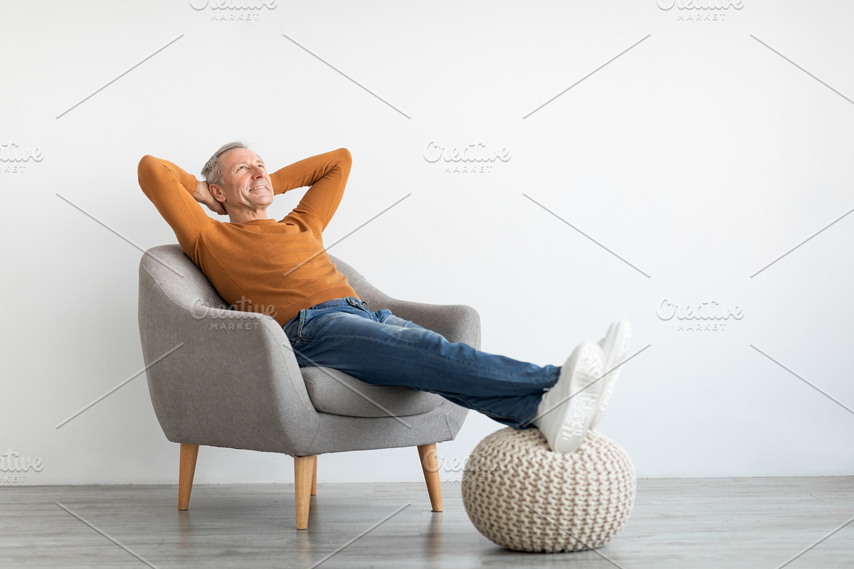 Mature man having rest at home on the chair, a Photo by Prostock-Studio (Photo 2 of 2)