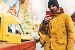 Writes a message on the smartphone stock photo containing hipster and yellow