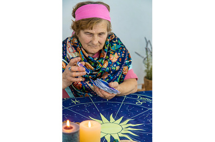 Fortune teller reads tarot cards, a Person Photo by yanadjana
