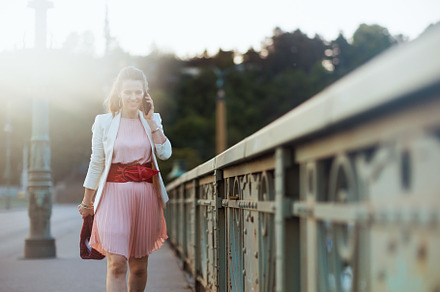 happy stylish 40 years old woman in city talking on phone, a Person Photo by Alliance Images