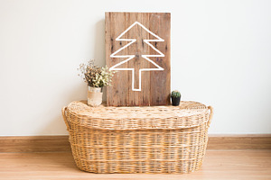 Christmas tree on wood frame in inte containing box, room, and tree