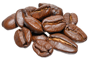 A handful of roasted coffee beans, shot close-up on an isolated, a Food & Drink Photo by ndanko