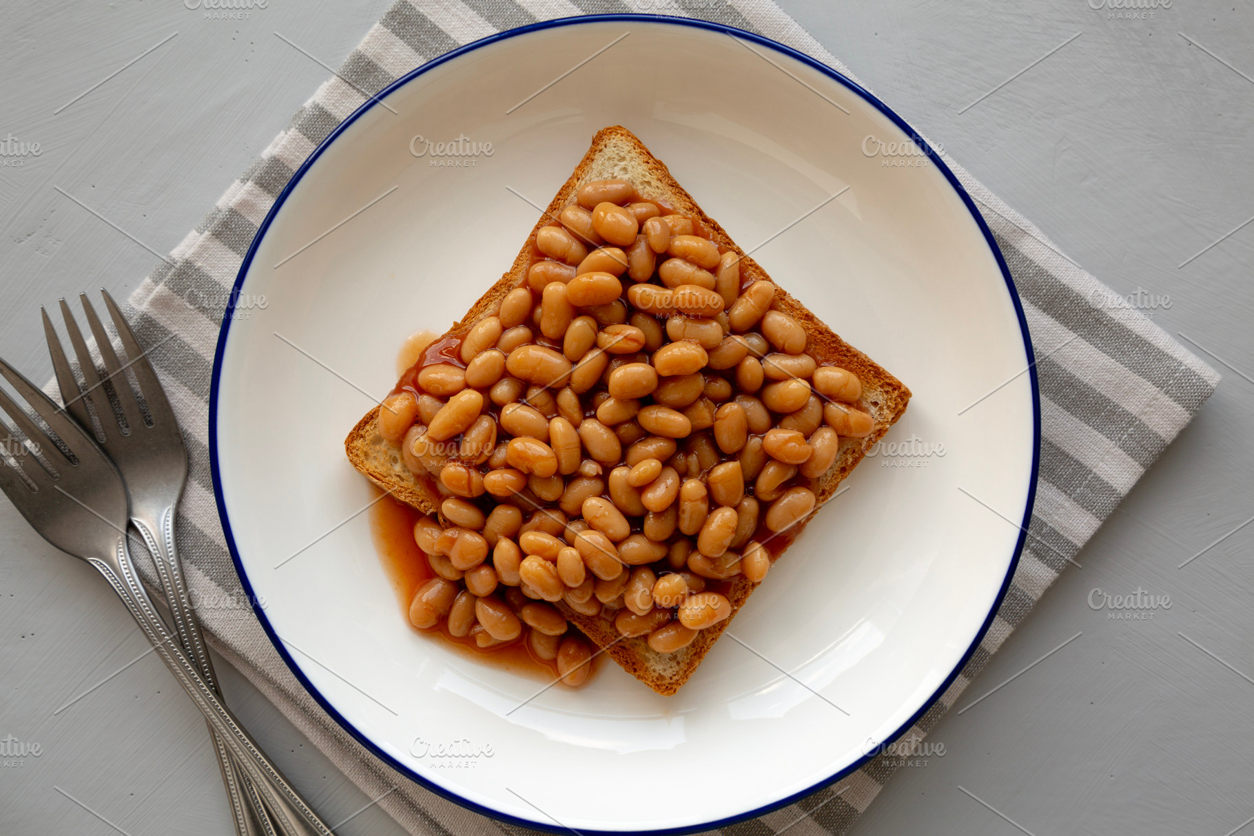 Homemade English Beans on Toast, top view., a Food & Drink Photo by LiudmylaChuhunova