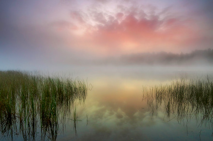 Sunrise over a misty lake featuring perspective, light, and haze, a Nature Photo by photoWorkshop