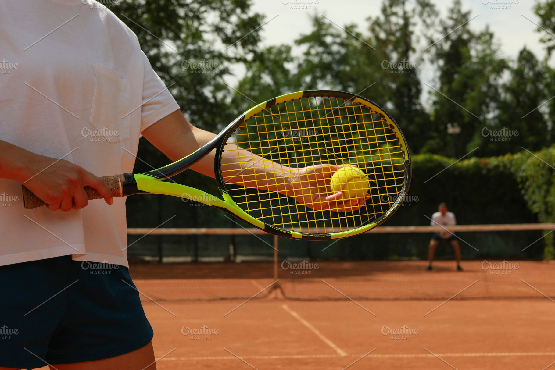 Woman hold racket and tennis ball on clay court, a Sports & Recreation Photo by AtlasStudio PRO