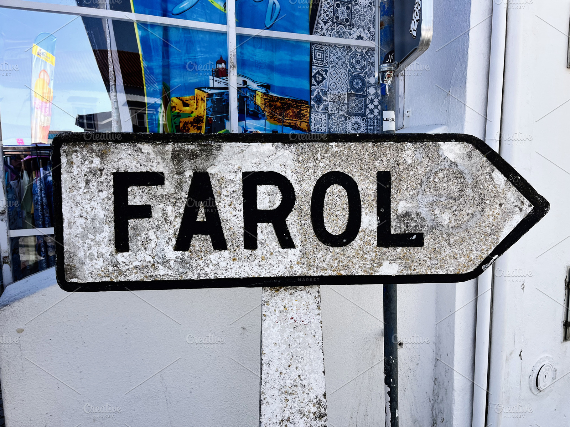 Rustic directional sign pointing to Farol in Nazare Portugal outdoors, a Photo by AS photostudio