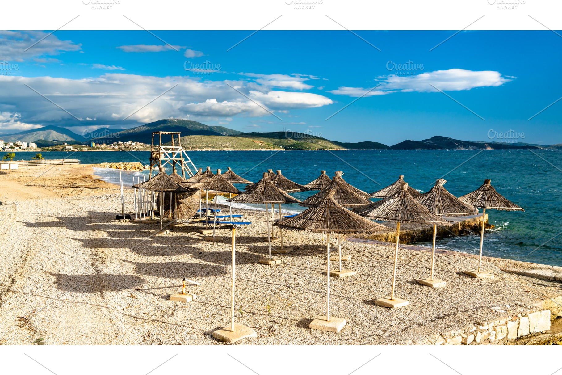 Straw umbrellas on a beach in stock photo containing beach and umbrella, a Nature Photo by Leonid Andronov
