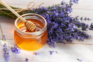 Honey jar with dipper and fresh lavender flowers, a Food & Drink Photo by Olena Rudo