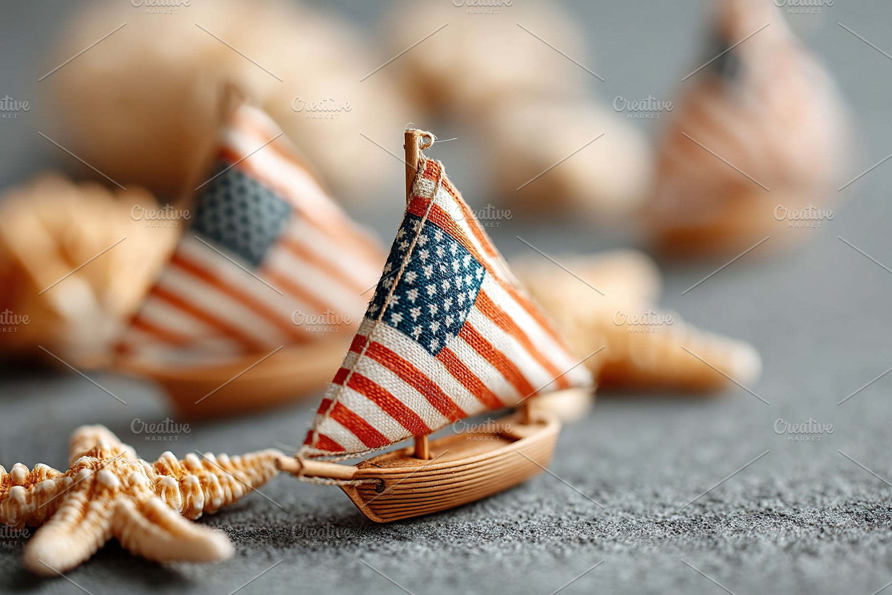 Miniature sailboats with American flags on a textured surface near seashells, a Holiday Photo by AlyaAnd