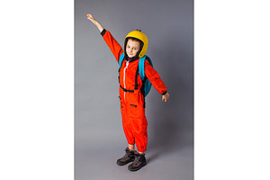 The little boy is posing in a