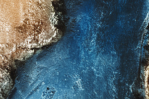 stone of two colors. square. blue saturated color and golden hue. texture and background