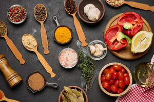 Spices, vegetables, and herbs on a dark background turmeric, pep, a Food & Drink Photo by ndanko