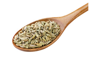 Fennel seeds in a wooden spoon close, a Food & Drink Photo by innakreativ