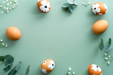 Happy Easter card design. Frame made of Easter eggs, eucalyptus leaves and flow, a Holiday Photo by photoguns