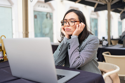 Bored inefficient woman office employee using laptop sitting at restaurant, a Photo by andreonegin market