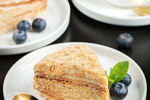 Medovik. Honey cake made from honey cakes with whipped sour cream, decorated wi, a Food & Drink Photo by Budarinphoto