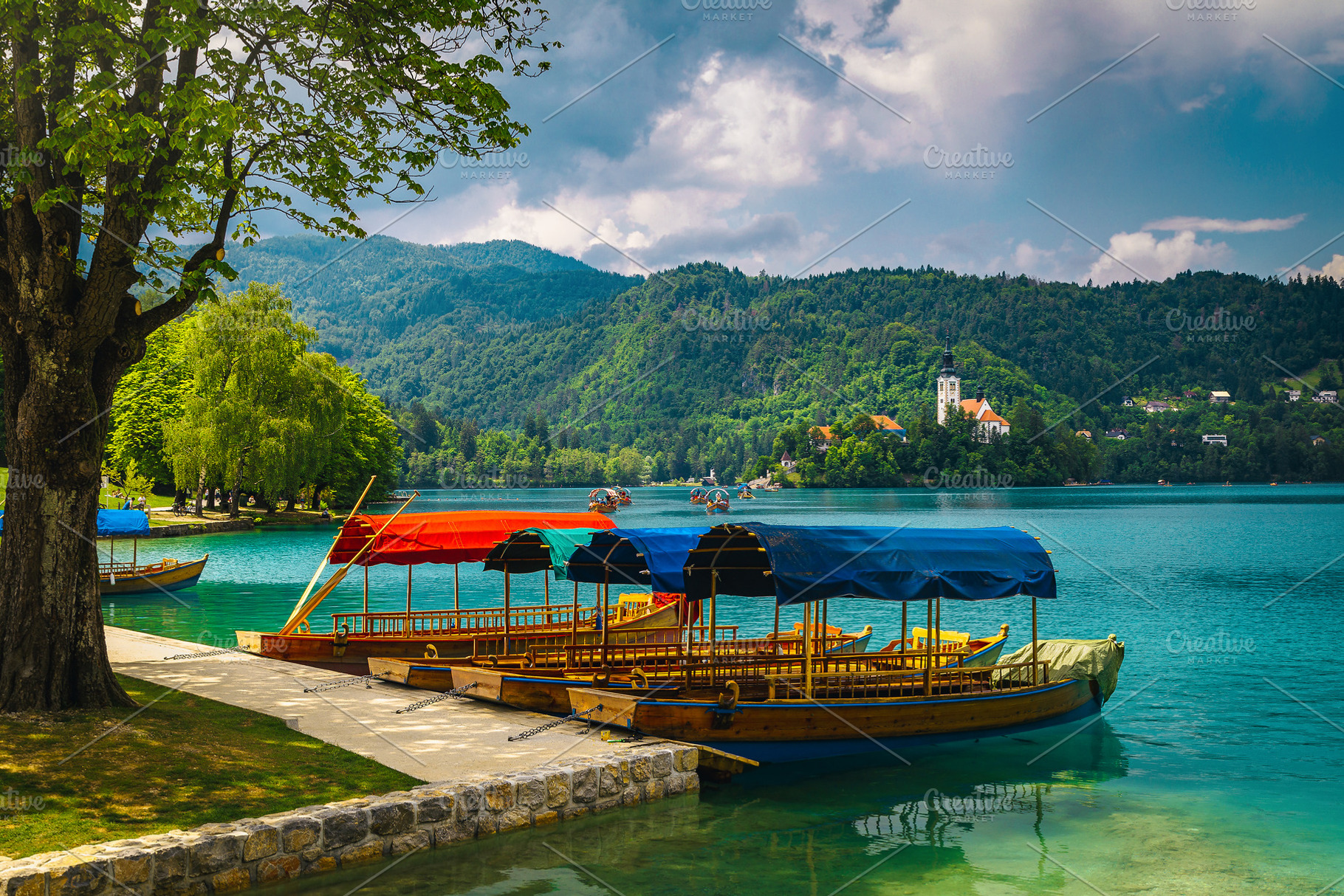 Anchored pletna boats on the lake, a Transportation Photo by Alpine Dreams