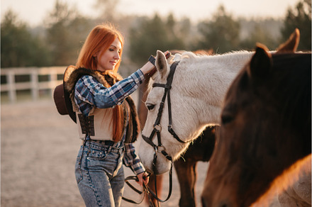 Woman farmer works with horses stock photo containing woman and ranch, a Person Photo by Maksym Zaitsev