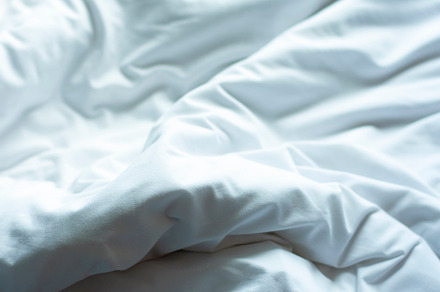 White sheets, wrinkled duvets.