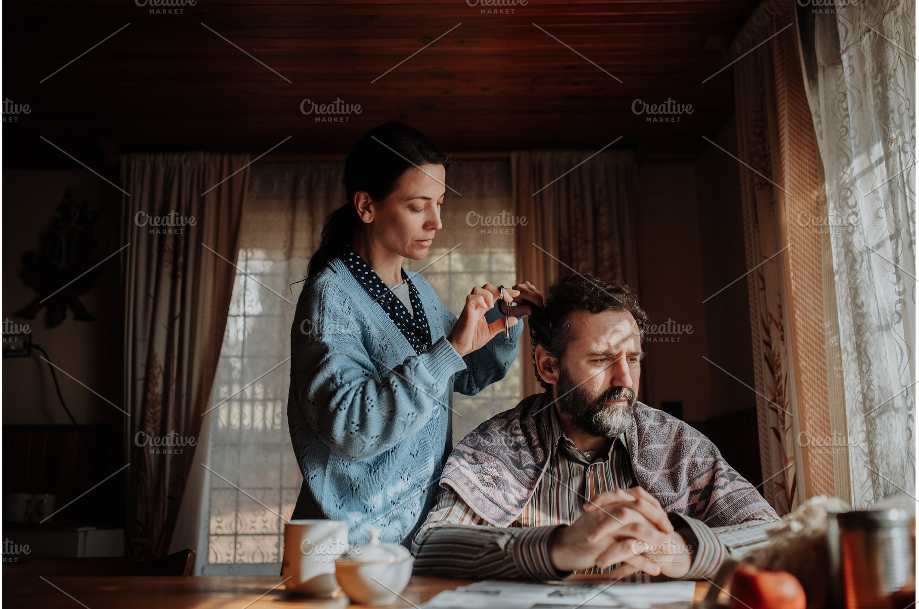 Woman cutting husband's hair at home, a Person Photo by HalfPoint