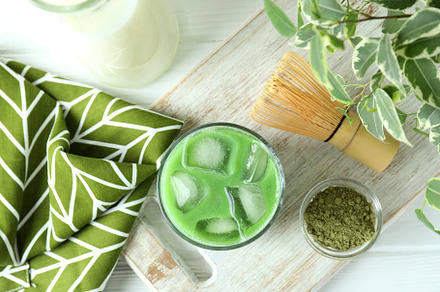 Matcha latte and accessories for making on white wooden table, a Food & Drink Photo by AtlasStudio