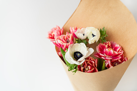 Beautiful red and white bouquet of tulips and anemones in kraft paper. The conc, an Abstract Photo by Artsaba Family