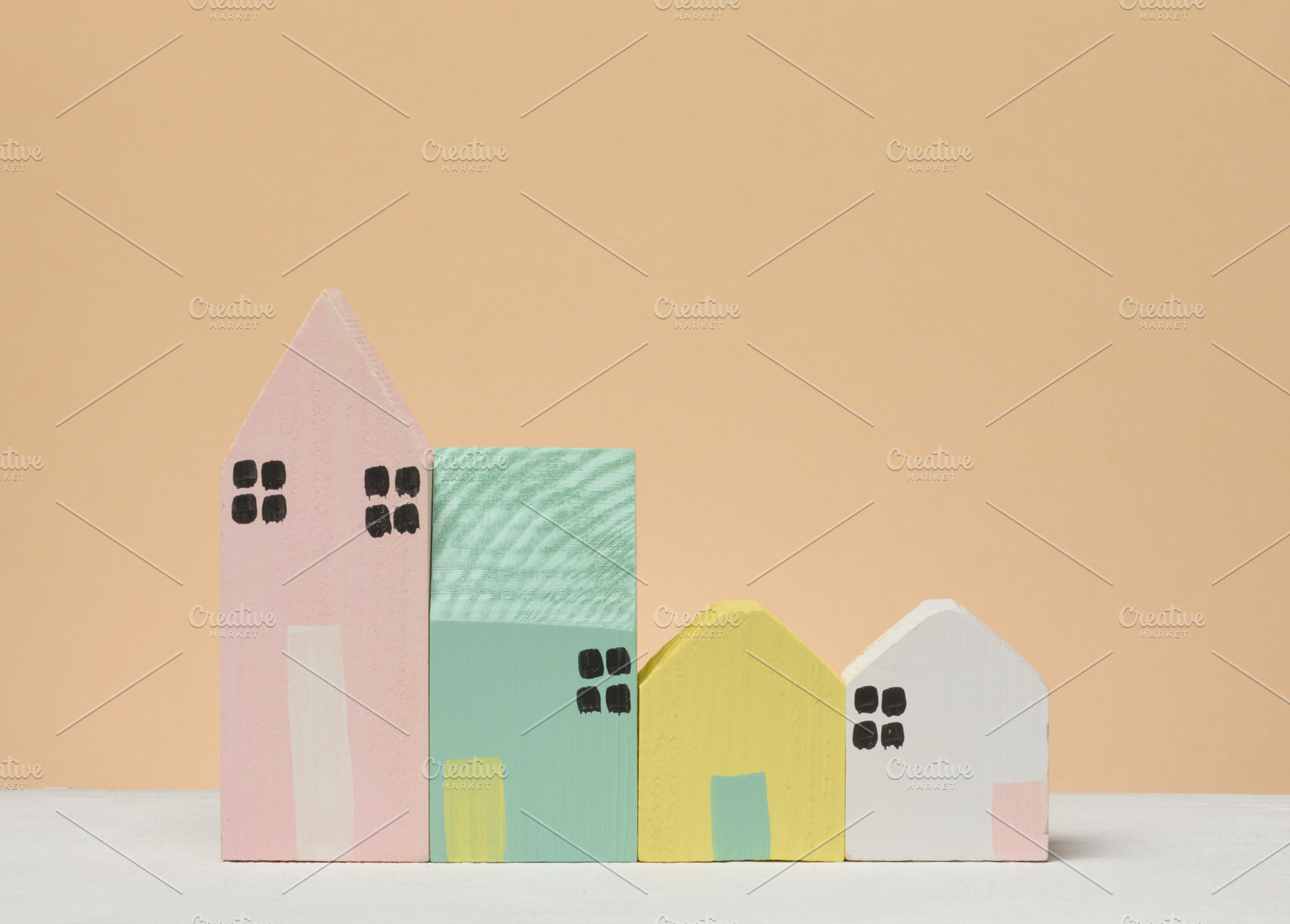 A row of stylized wooden houses of different sizes and colors on, a Business Photo by ndanko