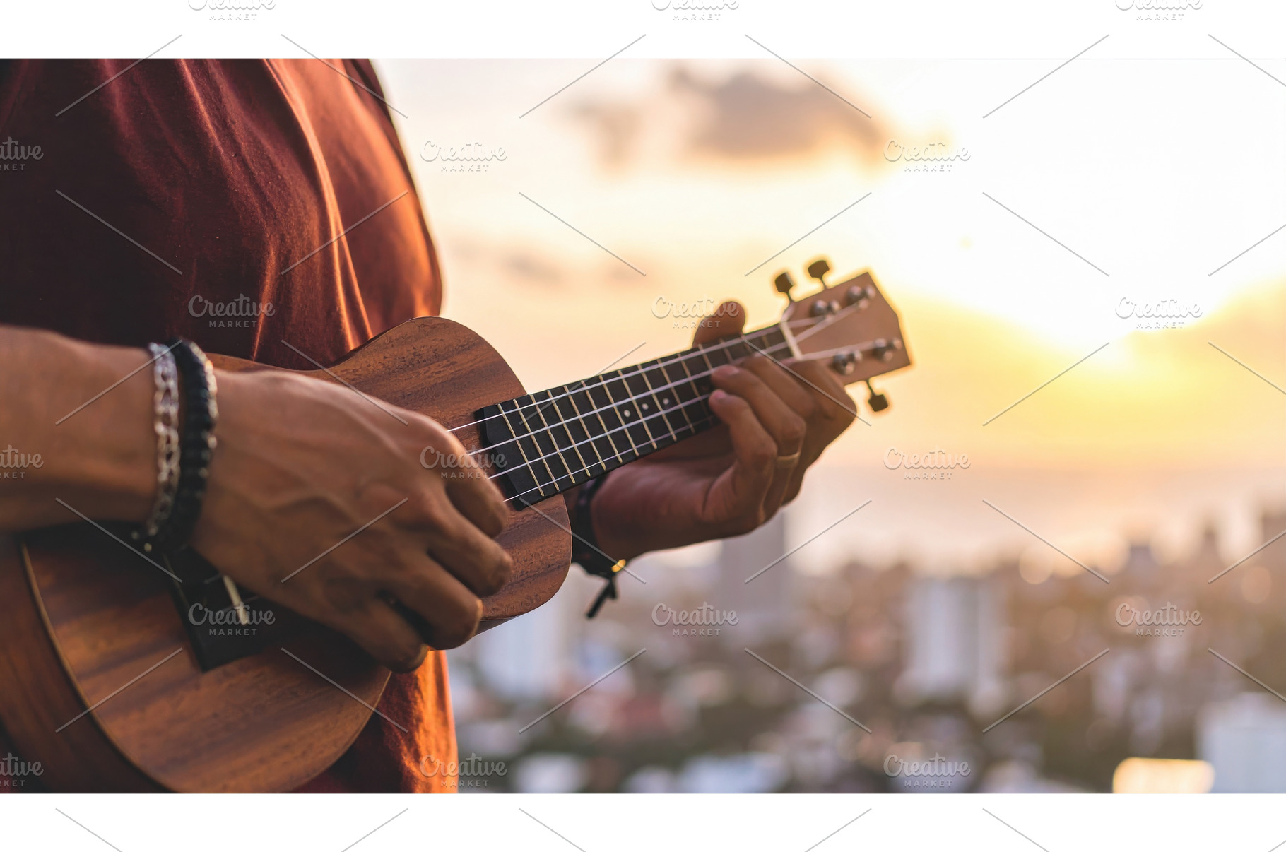 A person playing a ukulele at sunset, a Background Photo by Igor Tichonow