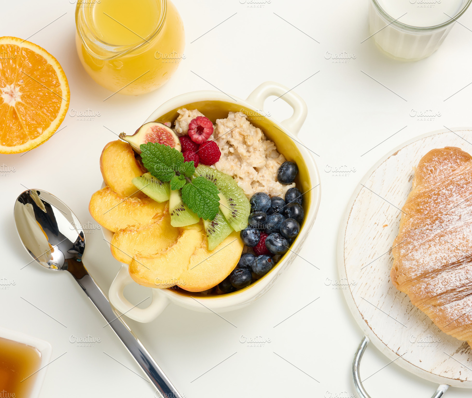 plate with oatmeal and fruit, half a ripe orange and freshly squ, a Food & Drink Photo by ndanko