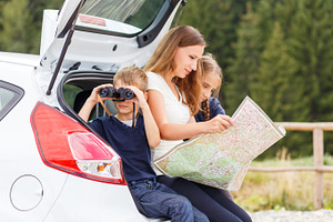 Family travelling by car and using map to navigate stock photo containing