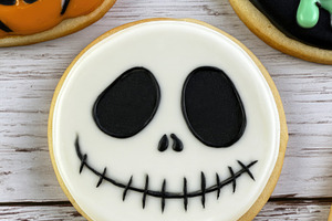 Halloween skull face cookie with black icing on wooden backgroun, a Food & Drink Photo by José Manuel Gelpi