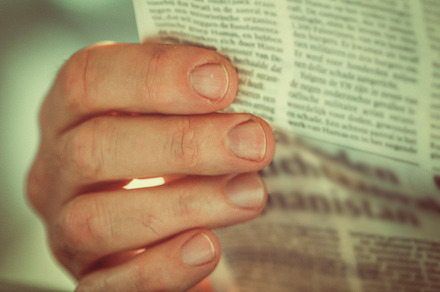 Hand holding newspaper, a School & Education Photo by Patricia Hofmeester