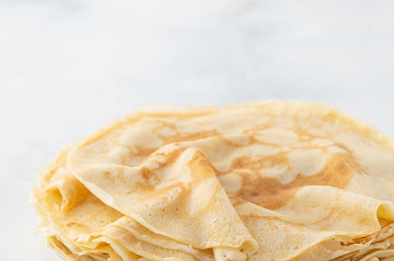 Crepes thin pancakes with honey on containing white, thin, and plate