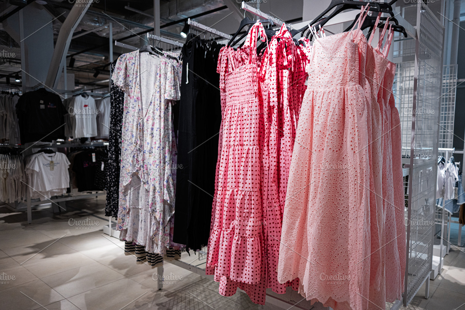Wide selection of dresses on racks inside a retail clothing store, a Photo by AS photostudio
