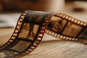 Film strip on wooden surface, a Photo by Beautiful things