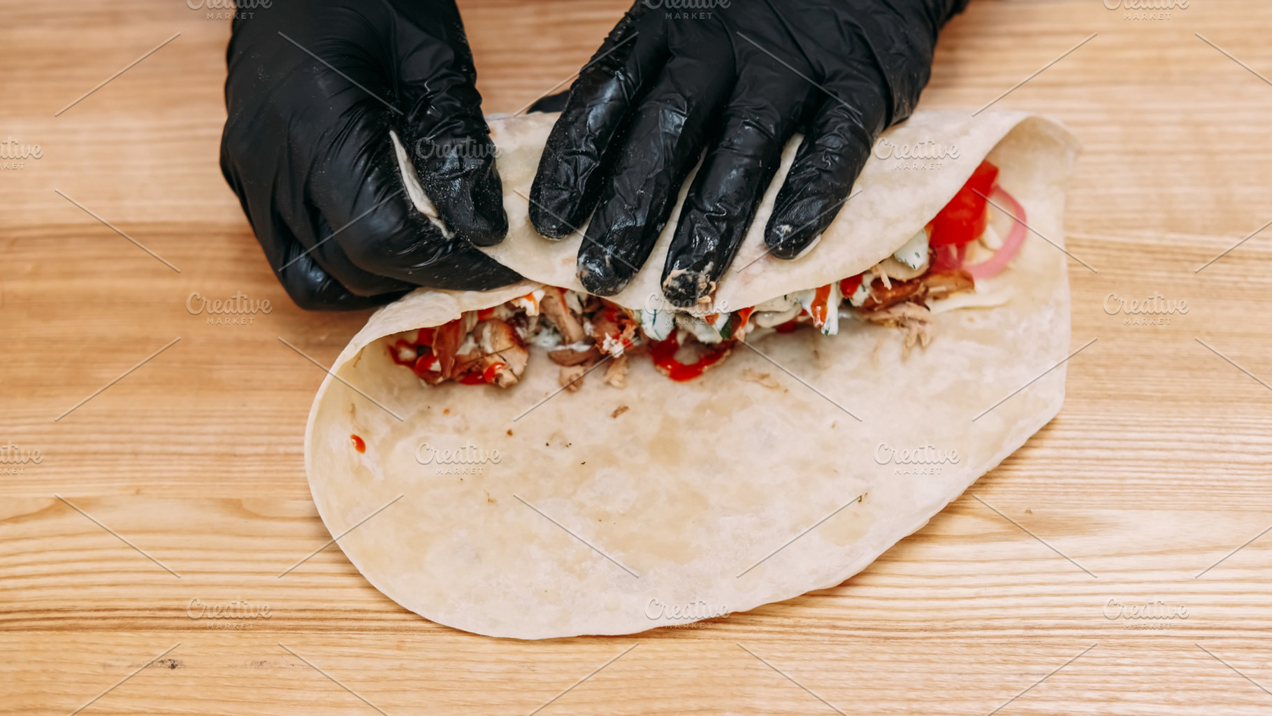 Pita sandwich preparing burrito chef shawarma hand, a Food & Drink Photo by Photo Drive Studio