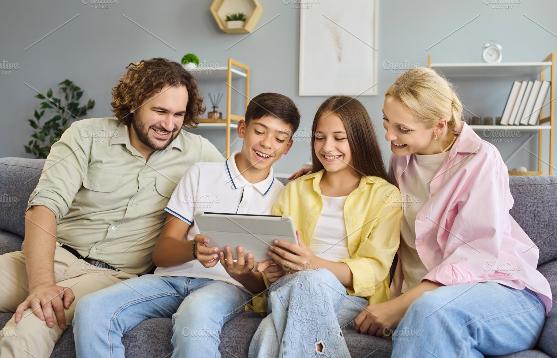 Family with Teens Sharing Tablet, a Person Photo by StudioRomantic