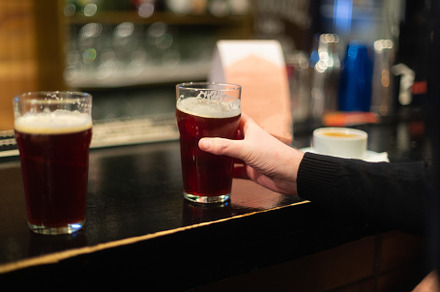 Beer glasses with dark beer are on t containing beer, glass, and alcohol, a Food & Drink Photo by oleghz