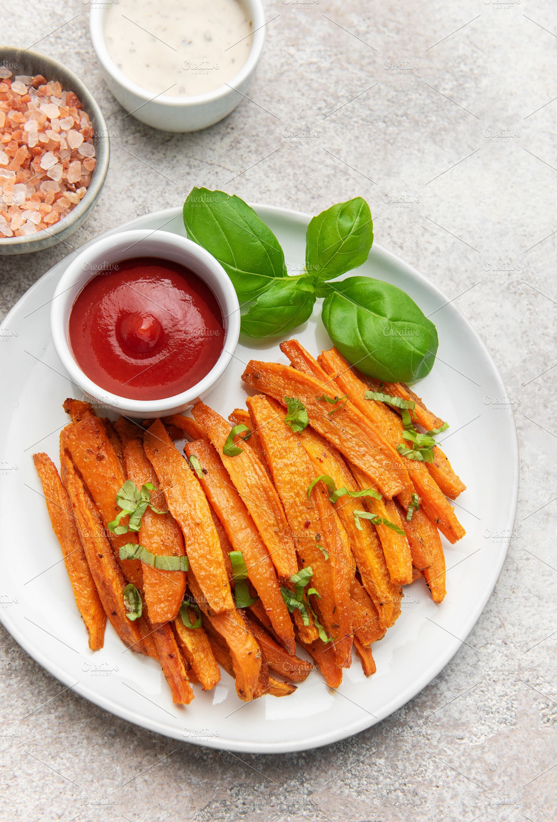 Sweet potato fries with ketchup and basil on plate, a Food & Drink Photo by Olena Rudo