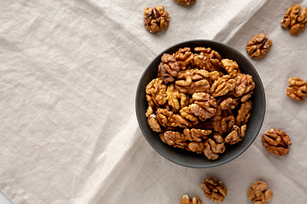Raw Walnut Halfs in a Bowl, top view. Copy space.