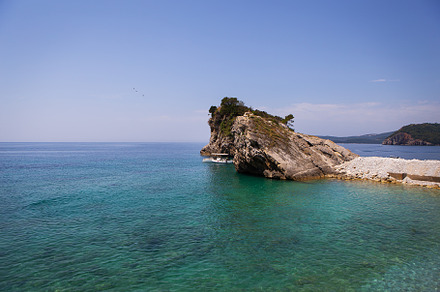 Very beautiful view of the sea and the rock, a small boat near the cliff, aquam, a Nature Photo by Artsaba Family