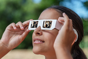 Young girl watches a solar eclipse, a School & Education Photo by Volff