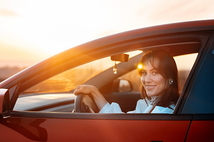 Woman posing inside a red car, a Person Photo by frimufilms